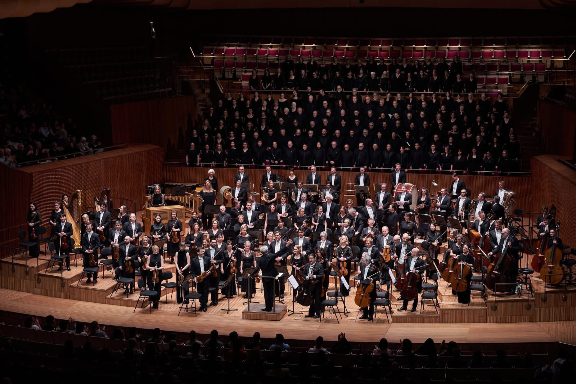 Erina Goldwasser taking a bow with the full orchestra and chorus on stage