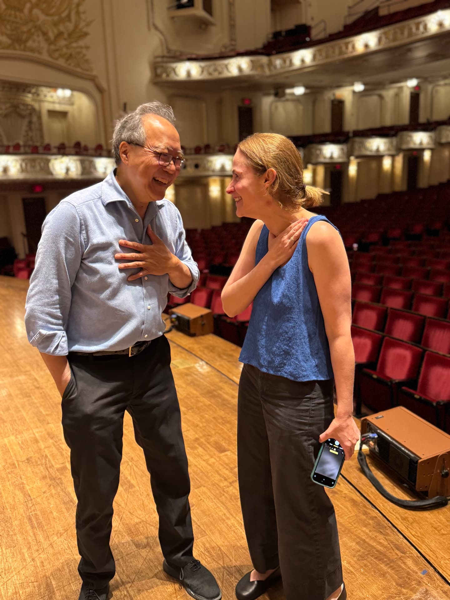 Erina Goldwasser sharing a laugh with Yo-Yo Ma during a rehearsal break